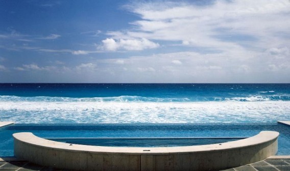 A pool with an ocean view and a sky background
