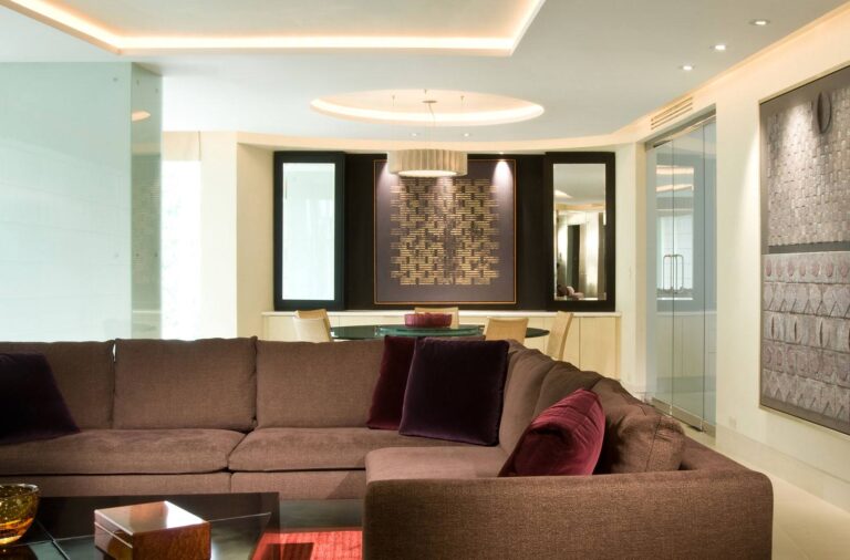 A living room with brown couches and a table