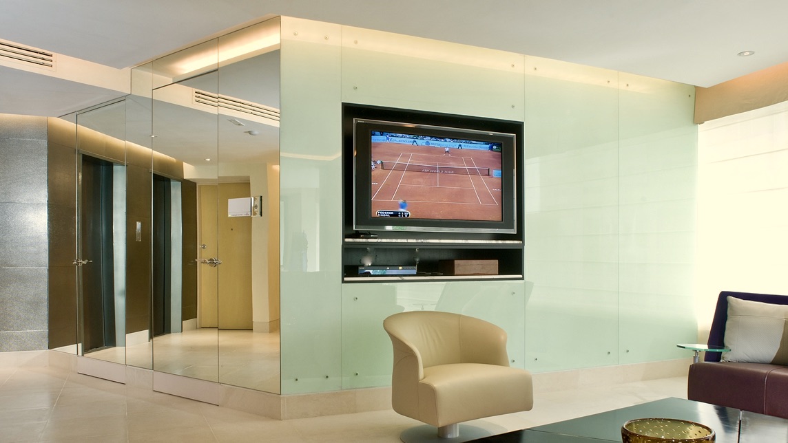 Polanco apartment TV Recessed in Glass wall elevator lobby Jerry Jacobs Design