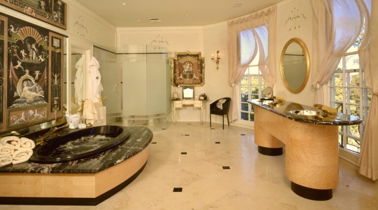A bathroom with marble floors and walls.